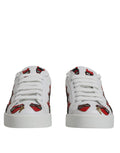 Baskets basses blanches dolce & gabbana portofino avec broderies rouges et noires de lèvres et yeux sur les côtés