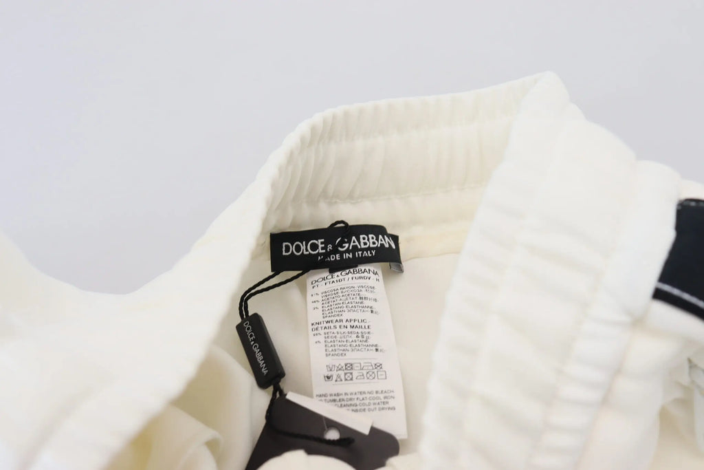 Étiquette blanche dolce gabbana avec logo dg noire et couture sur sweatpants blanc dolce gabbana