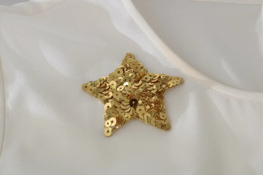 Broche étoile dorée pailletée brillante sur tissu blanc dolce & gabbana top fée brodé de cristaux et sequins
