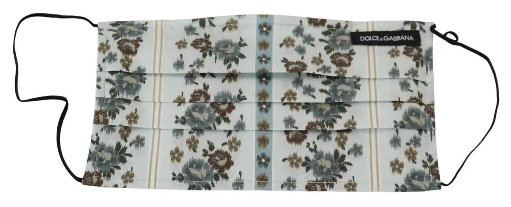 Masque facial en coton blanc à motifs floraux dolce gabbana avec plis et élastiques noirs sur fond bleu clair