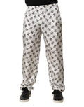 Pantalon de détente blanc dolce & gabbana en soie avec motif floral noir en tissu lisse et légèrement brillant