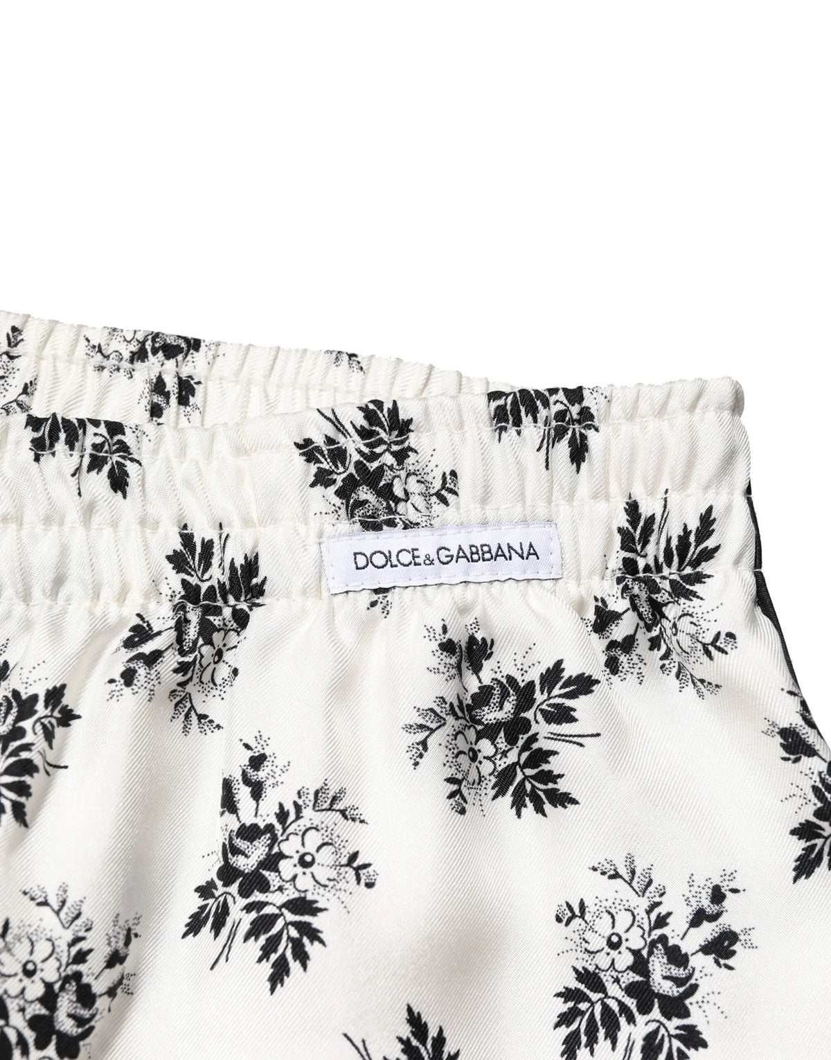 Dolce & gabbana white floral silk casual lounge pants featuring white shorts with a black floral pattern