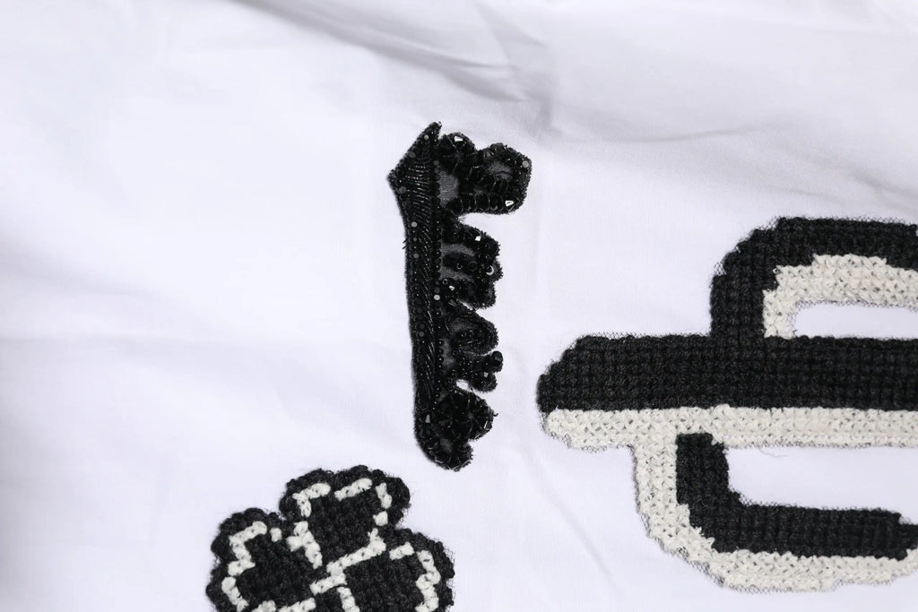 Peigne à cheveux noir en perles avec bord texturé en dentelle pour chemise brodée blanche en or dolce & gabbana