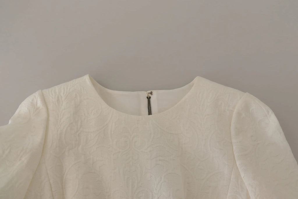 Blouse blanche texturée dolce & gabbana avec motif subtil et fermeture éclair centrale au col en jacquard brodé