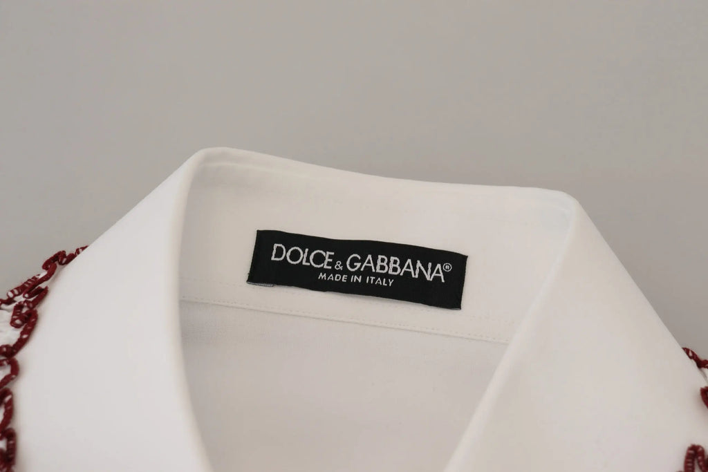 Blouse dolce gabbana blanche en dentelle à manches longues avec col à volants et détails perlés rouges