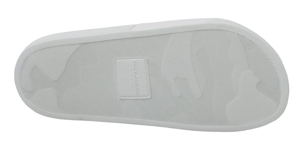 Semelle en caoutchouc blanc avec motif texturé subtil et petite étiquette rectangulaire des slides en cuir dolce & gabbana