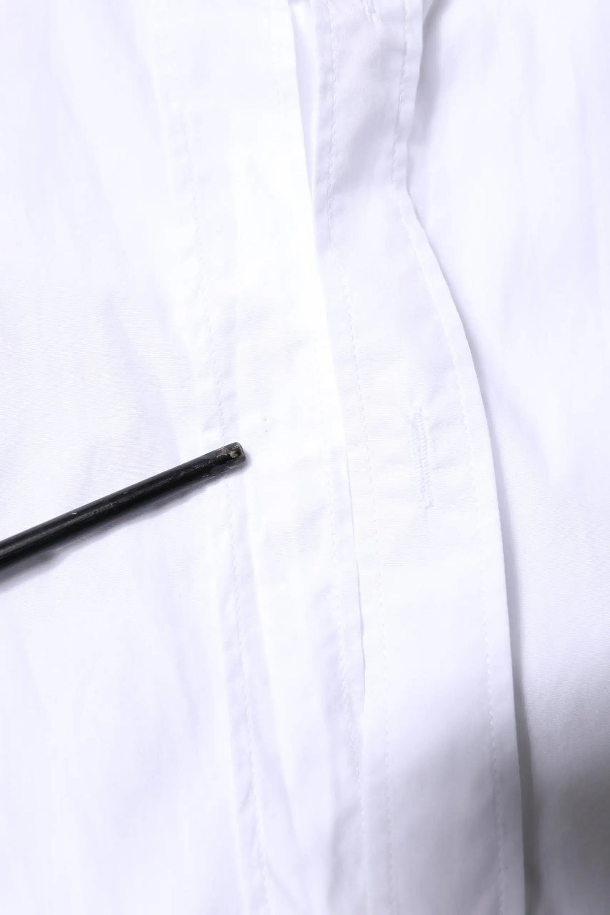 Stylo cylindrique noir posé sur tissu blanc d’une chemise homme formelle dolce & gabbana white martini en coton