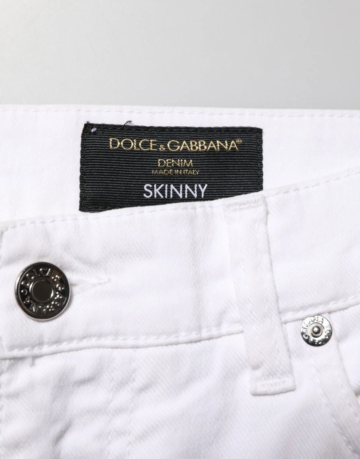 Jeans slim en denim blanc avec déchirures pour homme en coton dolce & gabbana avec étiquette noire visible