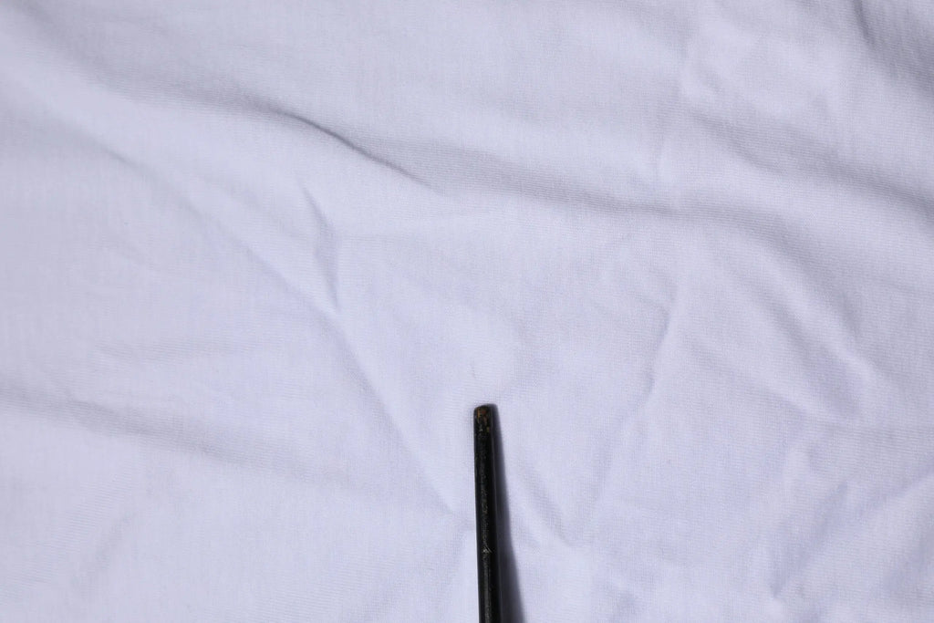 Objet cylindrique noir légèrement usé associé au t shirt dolce & gabbana blanc à manches courtes col rond