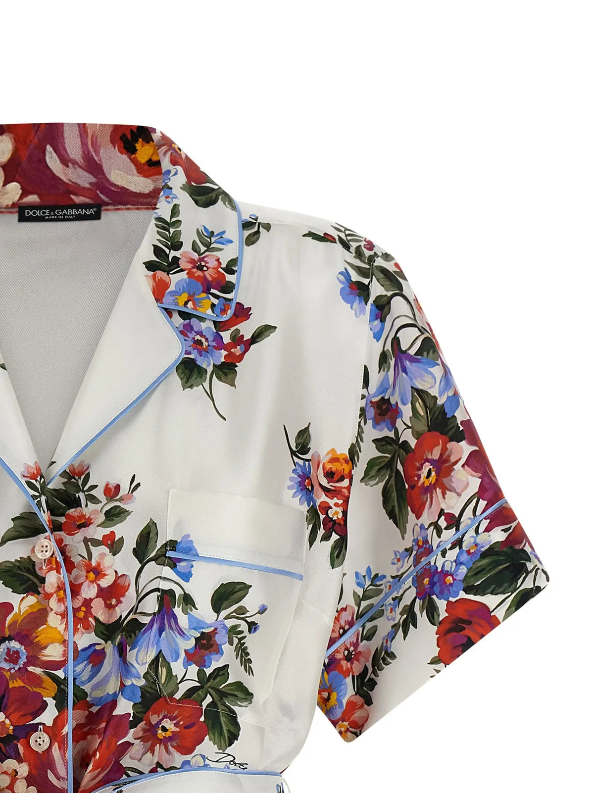 Blouse en soie blanche dolce gabbana avec imprimé floral vibrant rouge bleu orange et passepoil bleu clair