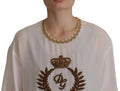 Blouse blanche en soie dolce gabbana avec col brodé or et blason central avec couronne et initiales entre feuilles de laurier
