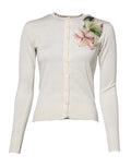 Cardigan crème en maille dolce & gabbana en soie blanche avec une délicate embellissement floral sur lépaule