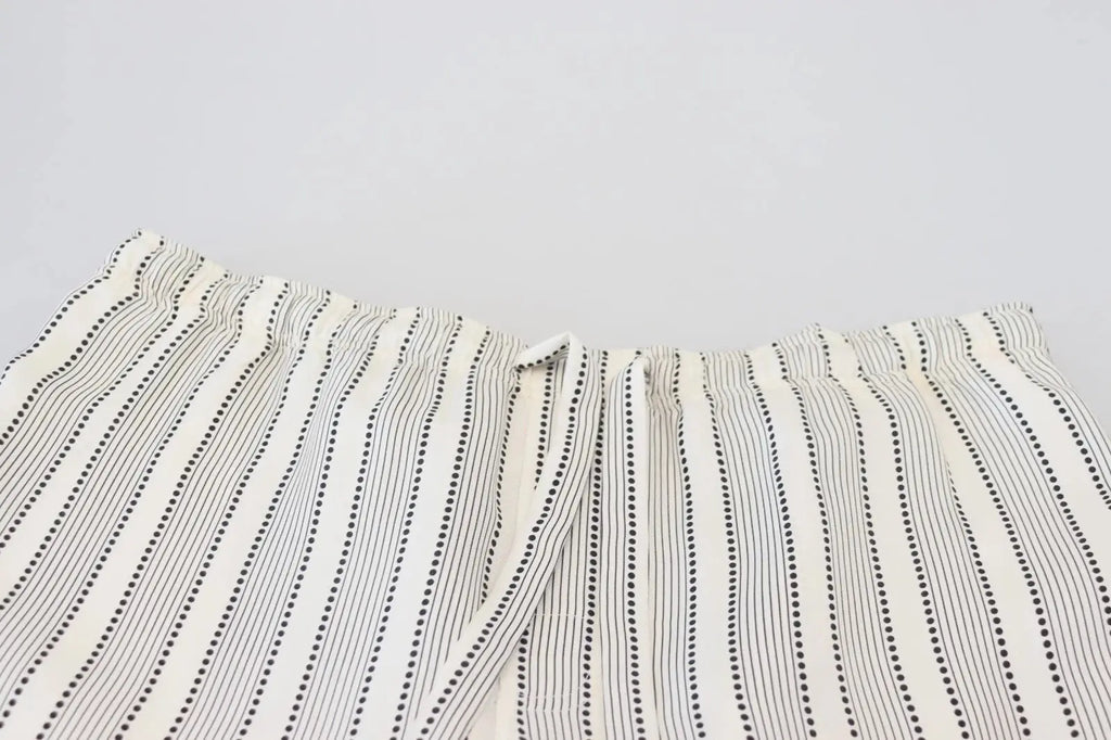 Un pantalon de détente en soie dolce & gabbana crème à rayures noires verticales avec motifs à pois