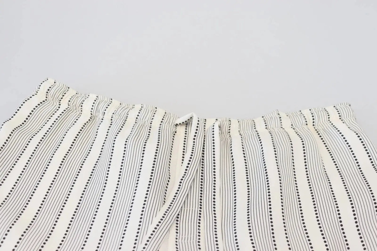 Un pantalon de détente en soie dolce & gabbana crème à rayures noires verticales avec motifs à pois