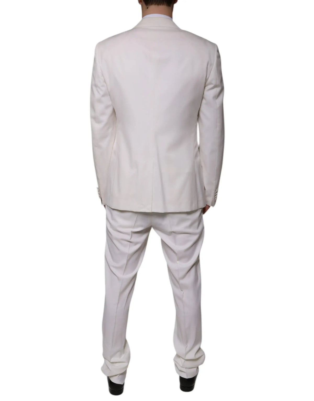 Un costume trois pièces slim fit blanc dolce gabbana en laine et soie avec une coupe classique et une texture subtile