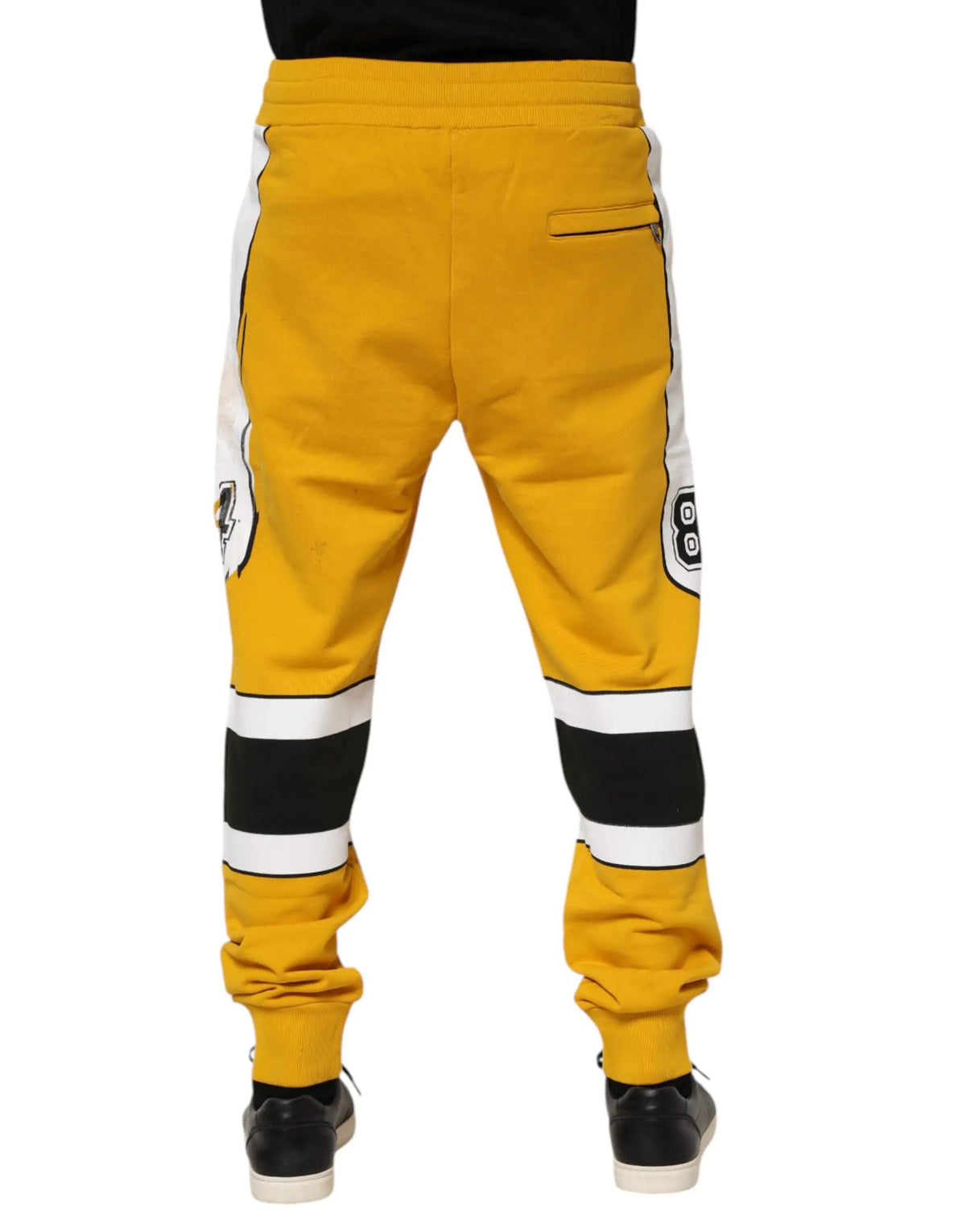 Pantalon jogger jaune dolce & gabbana en coton avec rayures blanches et noires et logos pittsburgh penguins sur les côtés