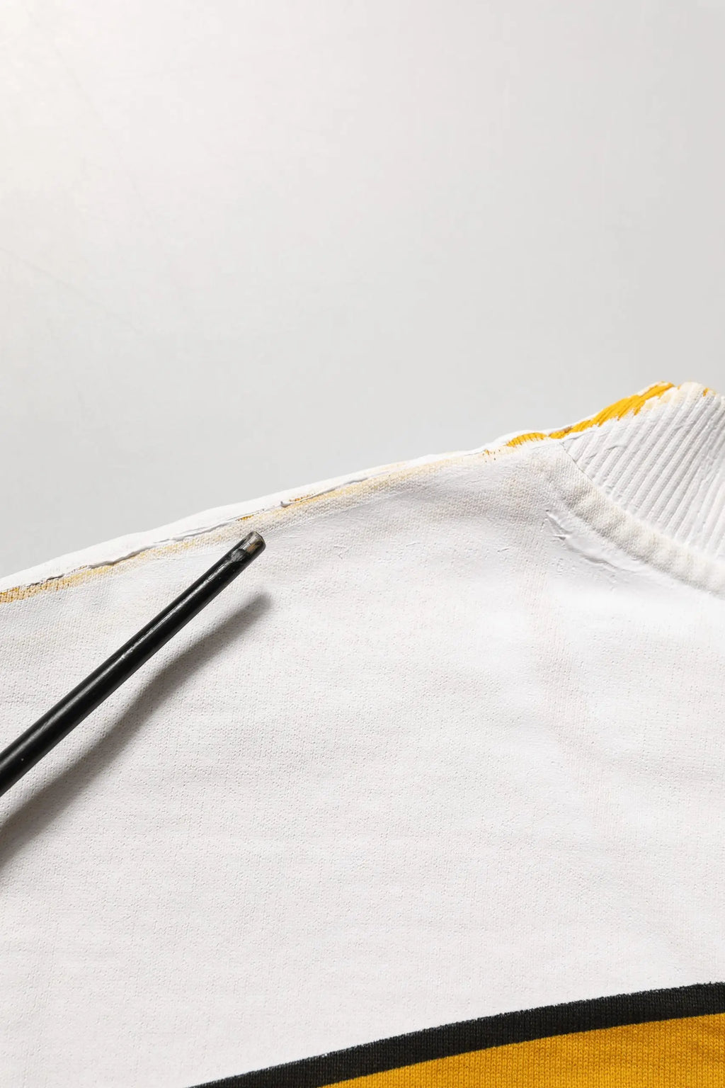 Pull dolce & gabbana blanc en maille avec col rond côtelé et bordure jaune détaillée