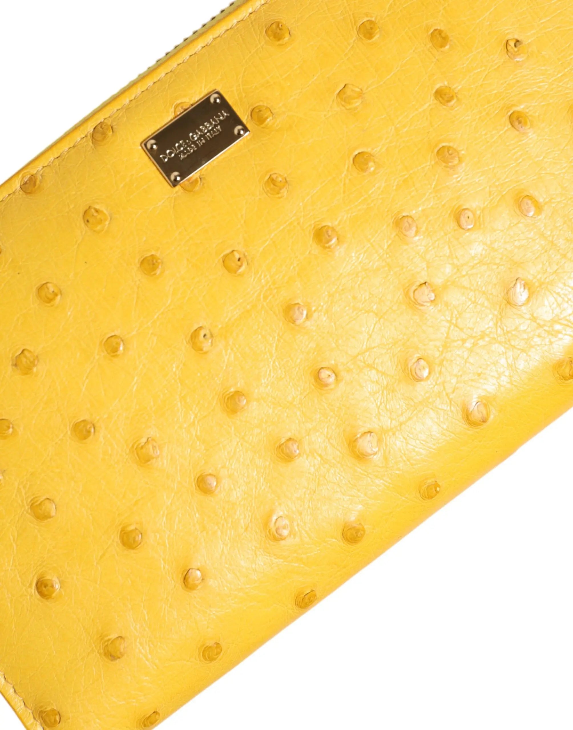 Clutch jaune vif en cuir dautruche avec plaque métallique dolce gabbana