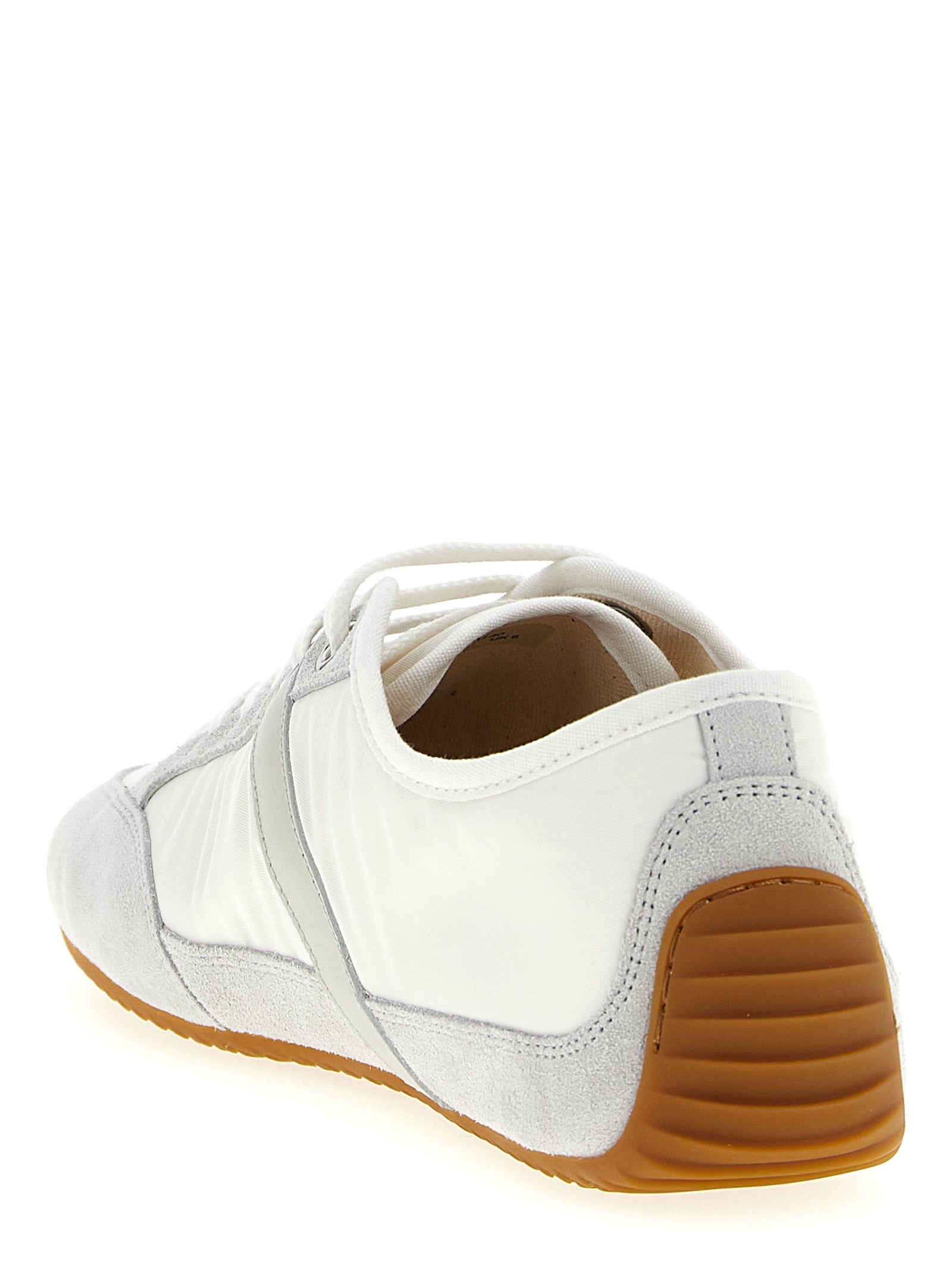 Baskettes basses Givenchy en polyamide blanches, vue de face avec semelle blanche et design épuré.