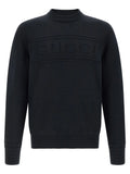 Pull gucci en maille noire avec poignets et ourlet côtelés et logo gucci texturé sur la poitrine en coton