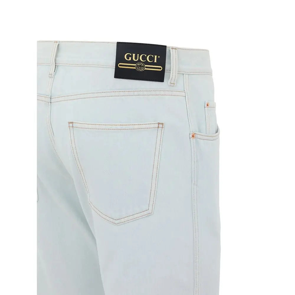 Jean gucci bleu clair en coton avec logo noir et lettrage doré au niveau de la ceinture