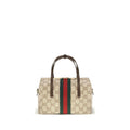 Sac à main en tissu beige de Gucci, élégance et style avec logo emblématique, vue de face avec poignée.