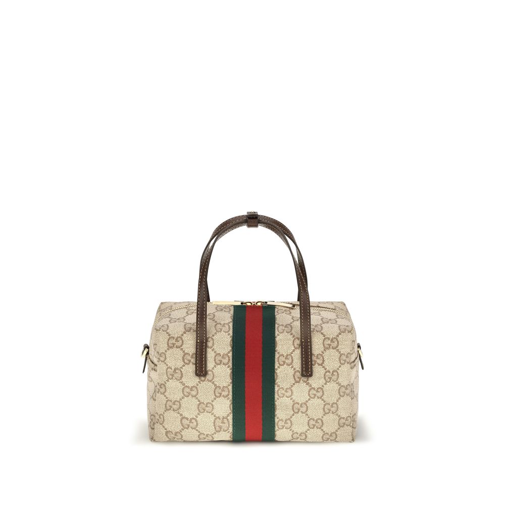 Sac à main en tissu beige de Gucci, élégance et style avec logo emblématique, vue de face avec poignée.