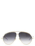 Lunettes de soleil en métal doré Gucci avec monture élégante et design moderne, vues de face.