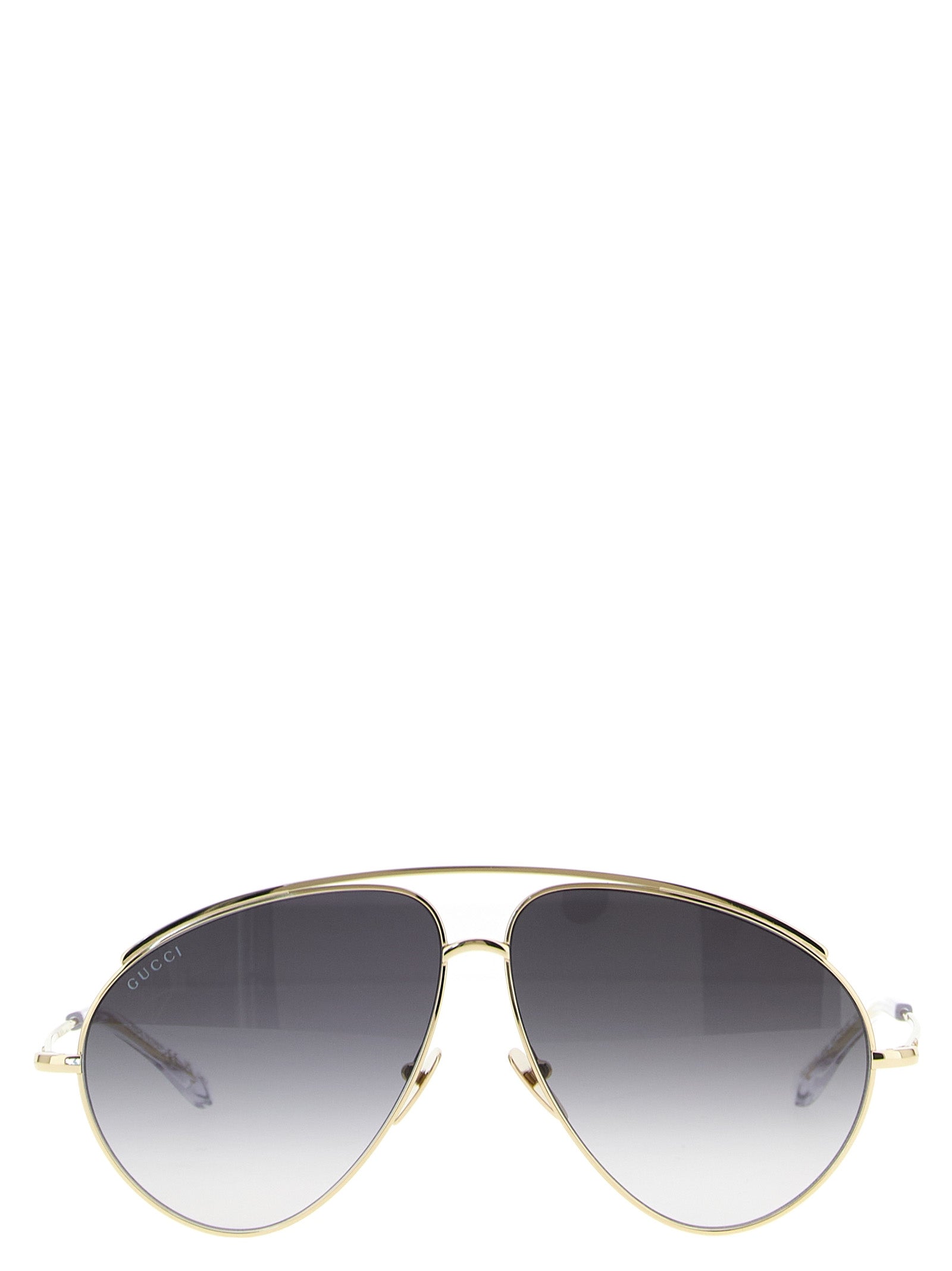 Lunettes de soleil en métal doré Gucci avec monture élégante et design moderne, vues de face.