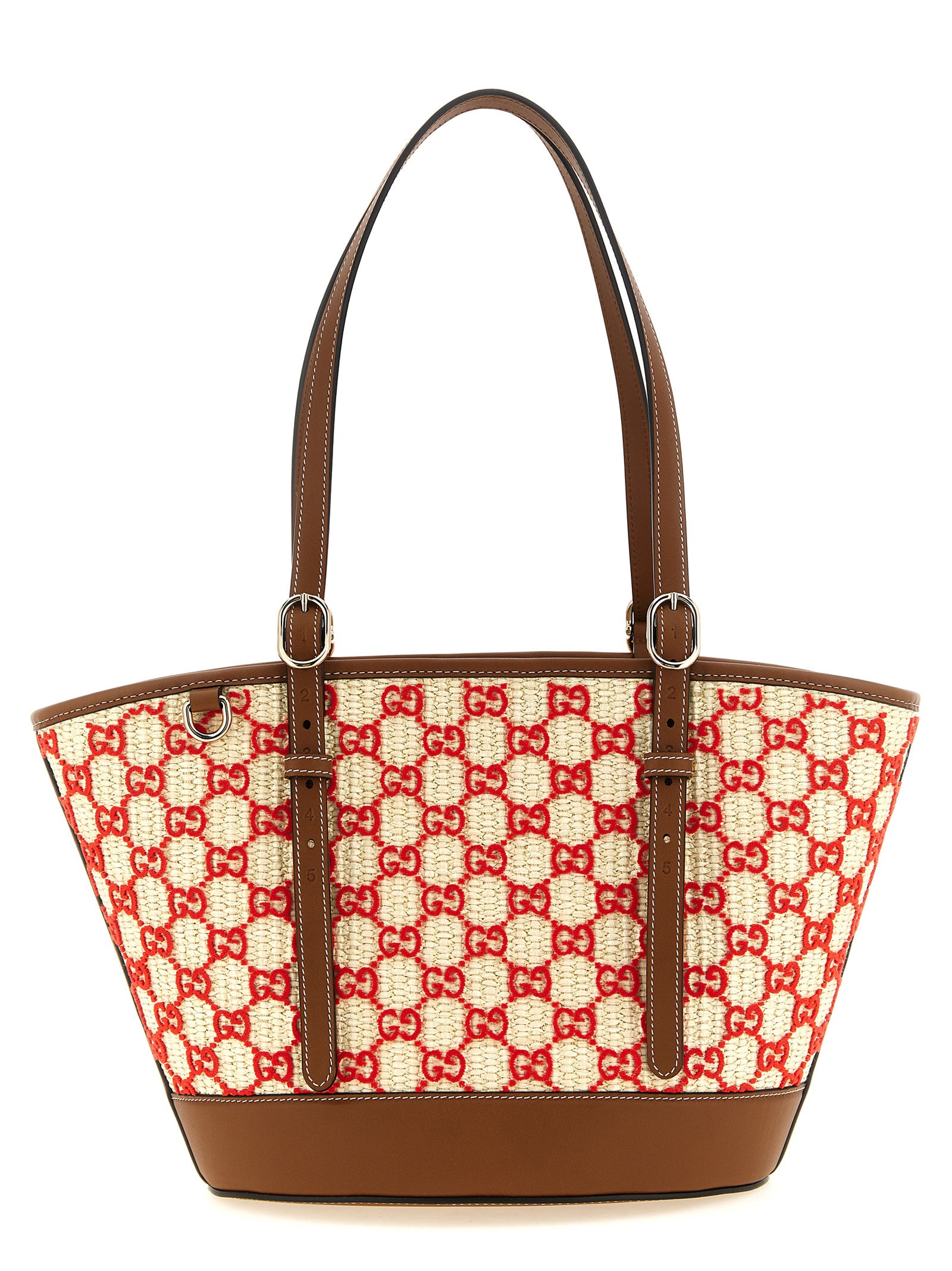 Sac à main en coton multicolore de Gucci avec logo, porté sur l'épaule, mettant en valeur le design coloré et le style luxueux.