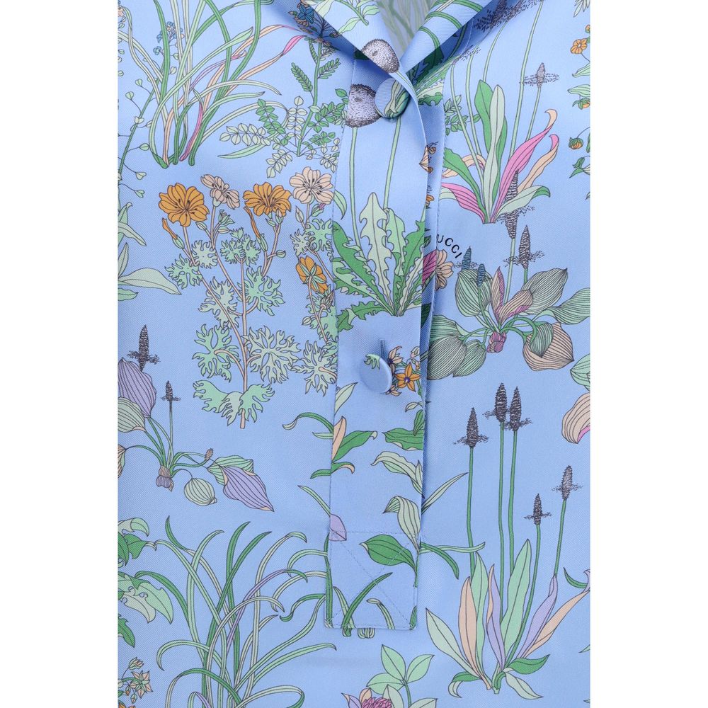 Chemise en soie bleue Gucci avec motif élégant, tissu fluide et style sophistiqué, vue de face.
