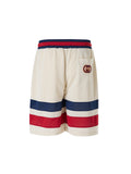Shorts en polyester crème Gucci avec logo, style décontracté et moderne, visibles dans cette image.