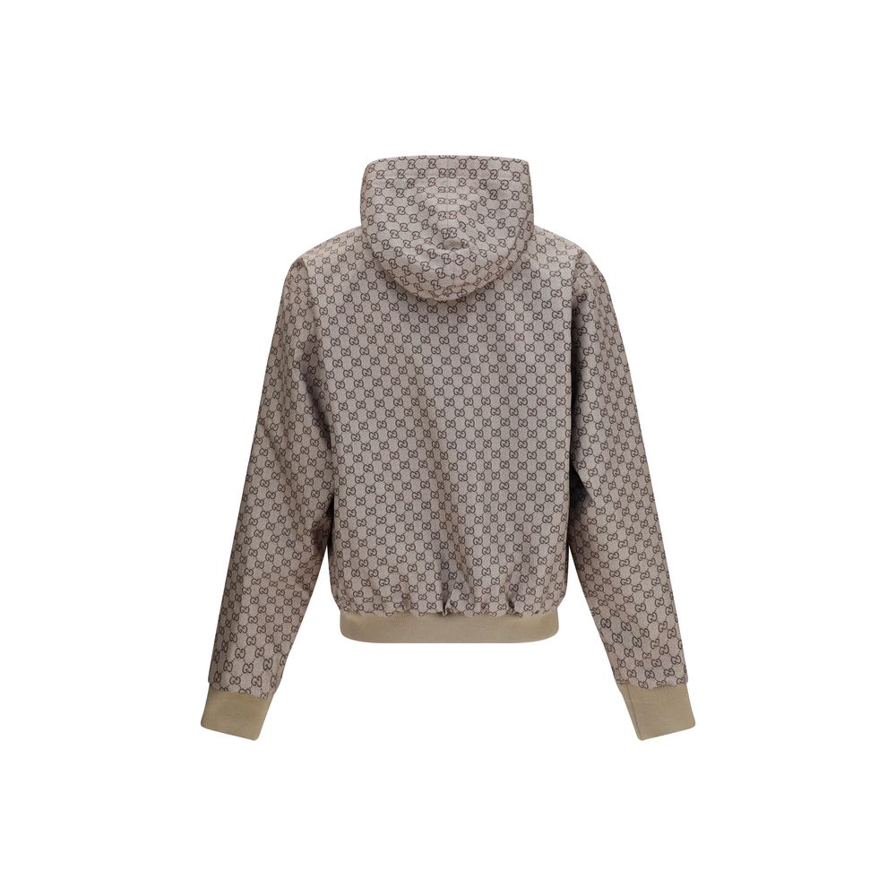 Veste en polyester noire Gucci, vue de face, avec logo Gucci visible sur la poitrine, style moderne et élégant.