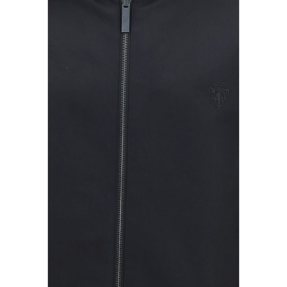 Veste noire en polyester Gucci pour homme, style moderne avec logo Gucci visible sur le devant.