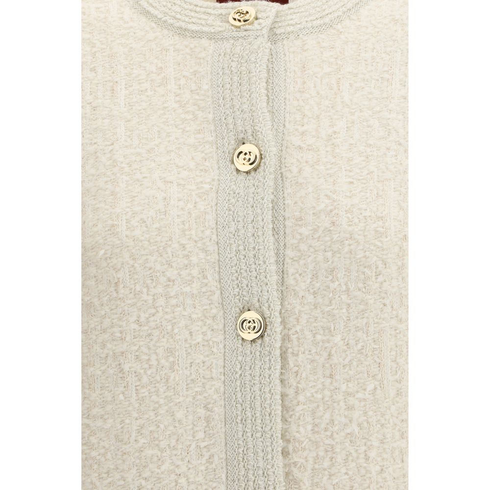 Cardigan en laine beige Gucci, coupe classique, avec détails élégants visibles sur l'image.
