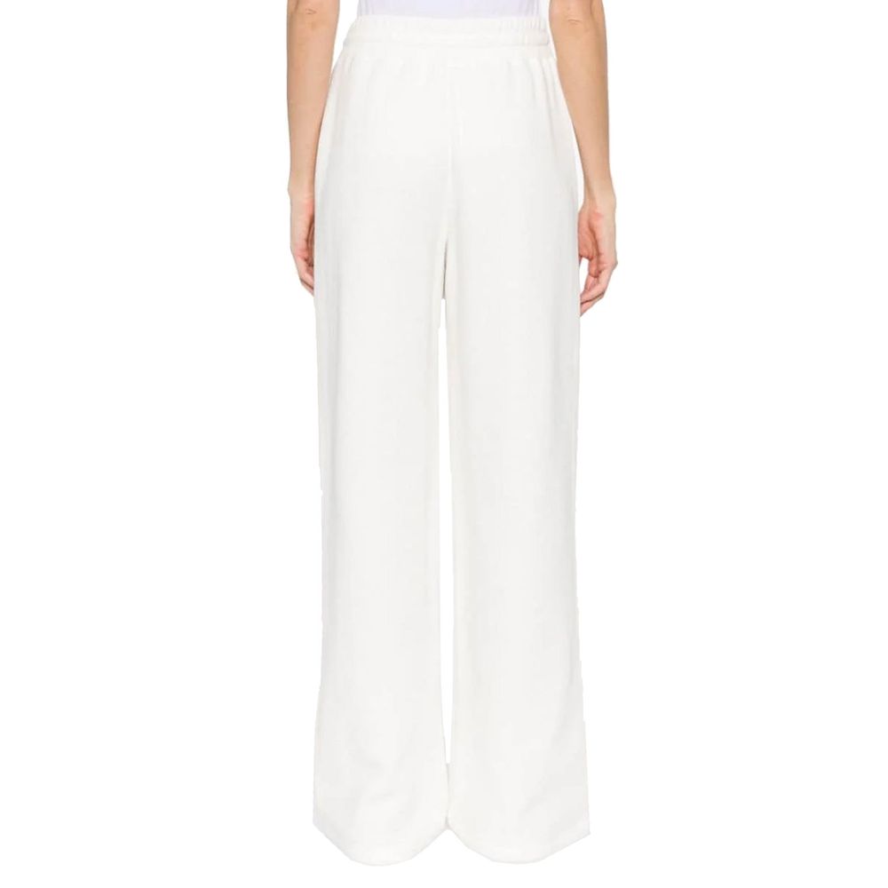 Pantalons de sport en coton blanc Gucci, joggers de fitness avec logo Gucci visible, pour homme ou femme.