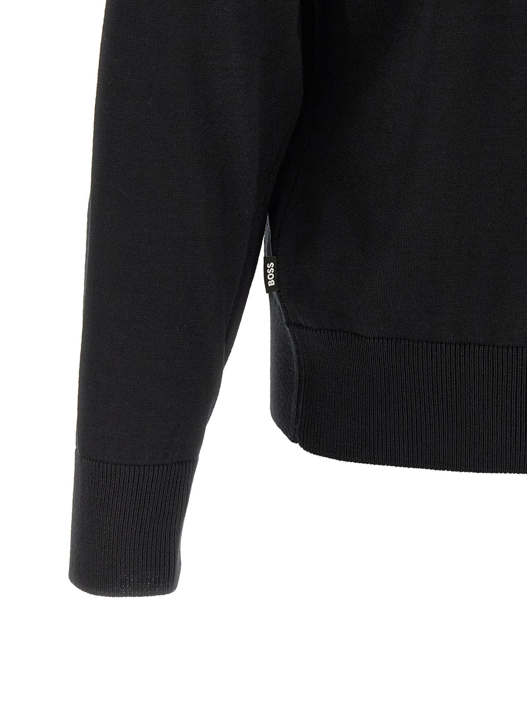 Cardigan noir en laine vierge de la marque Hugo Boss, doux et élégant, porté sur un mannequin.