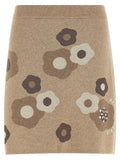 Jupe longue beige en laine de la marque Kenzo, coupe élégante et confortable, portée avec un haut tendance.