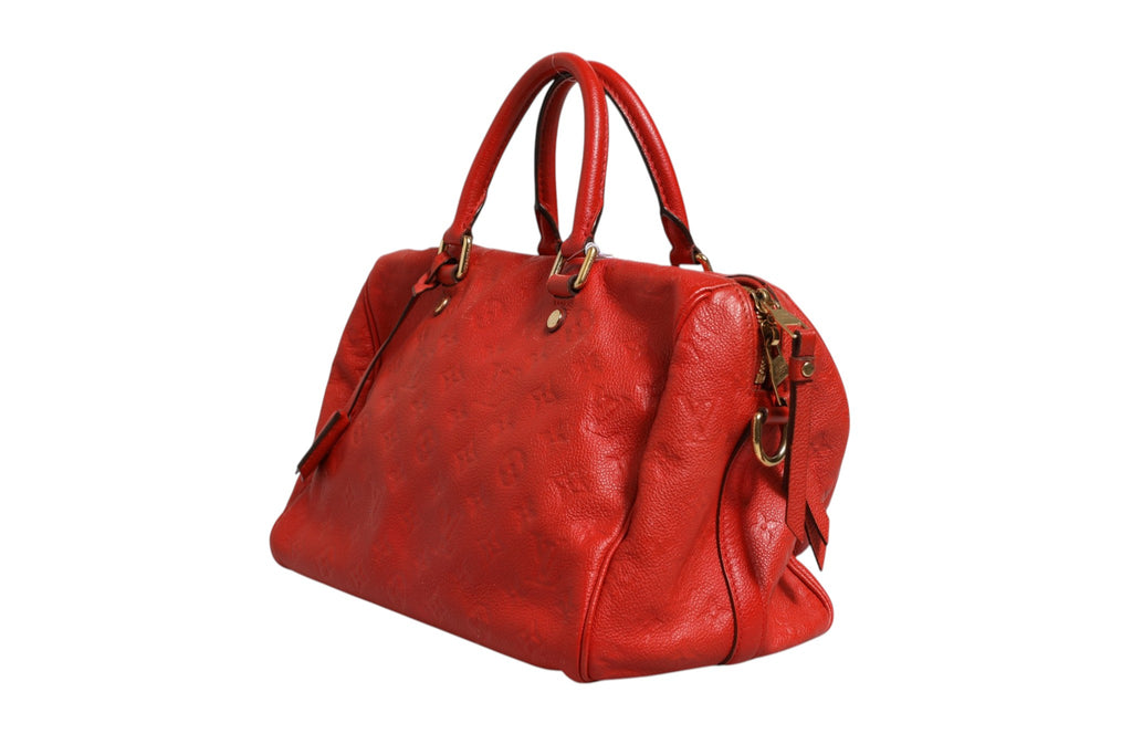 Sac à bandoulière Louis Vuitton Speedy 30 en Monogram Empreinte rouge, avec poignées en cuir et logo emblématique.