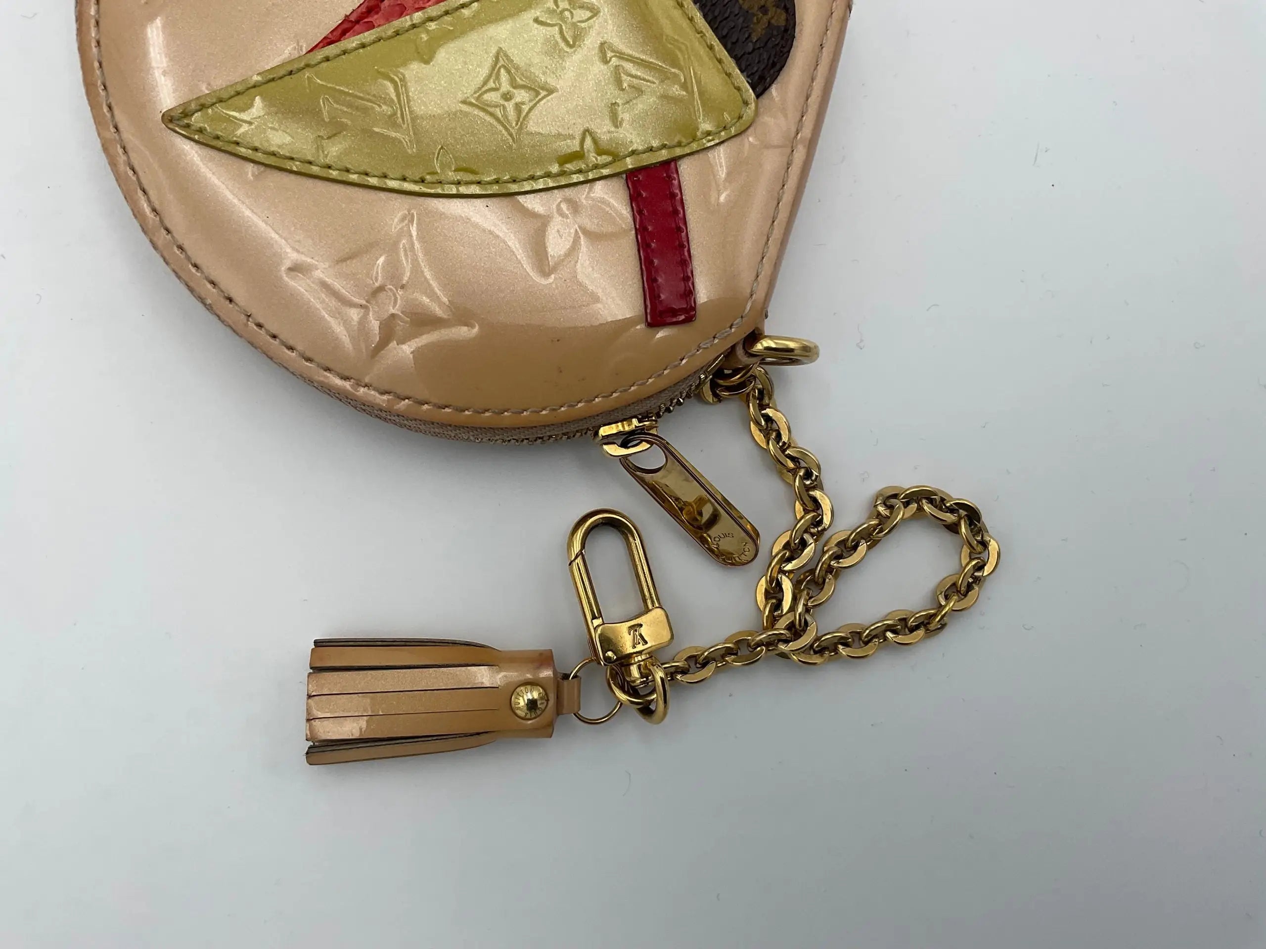 Beige patent leather louis vuitton micro boite chapeau coin purse with gold hardware and red accent panel