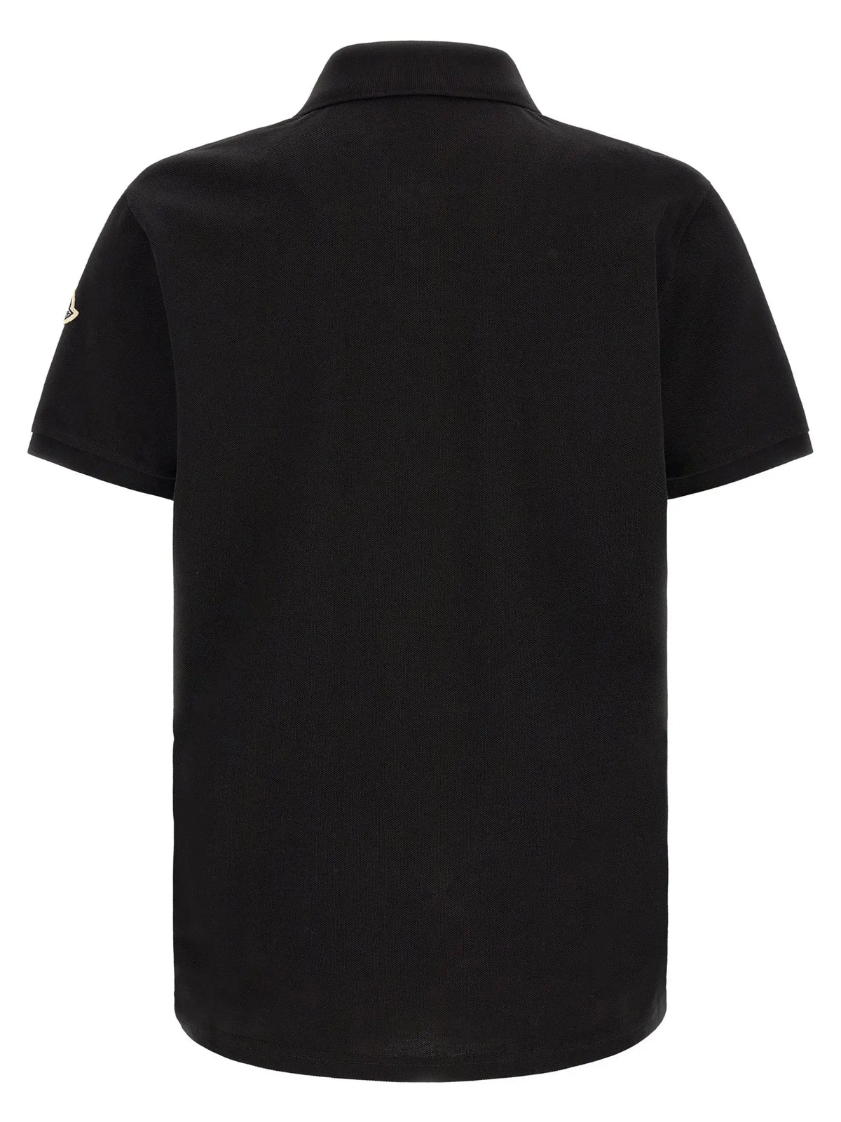 Polo noir en coton moncler à manches courtes avec logo discret sur la manche gauche
