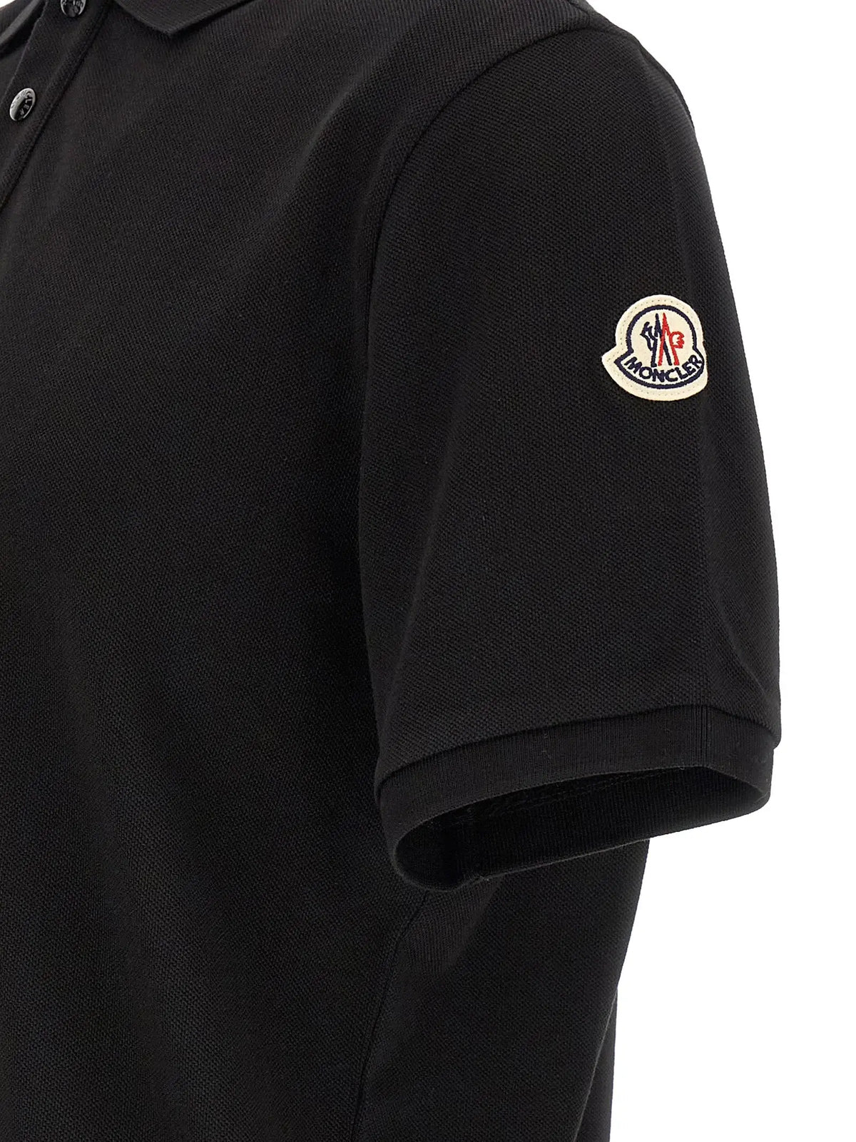 Polo noir moncler en coton avec tissu texturé et patch logo circulaire sur la manche