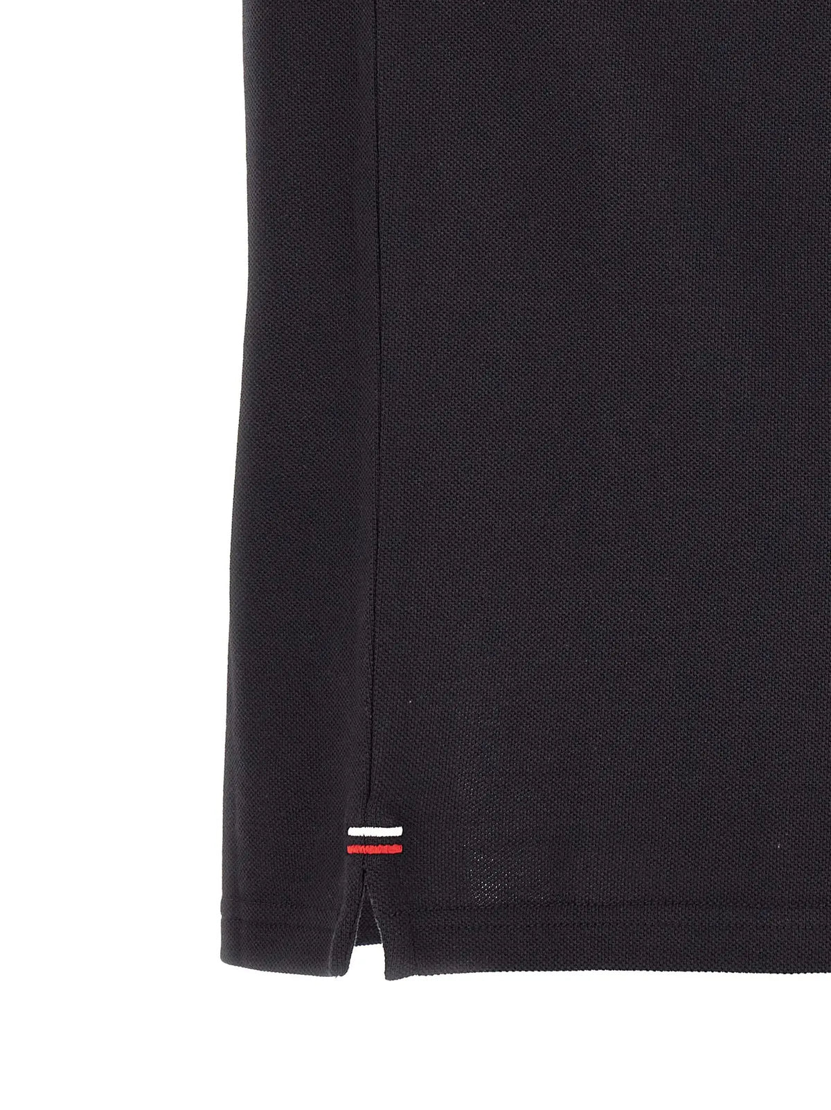 Moncler blue cotton polo shirt with subtle pique knit texture and small red white and blue striped logo tag at hem