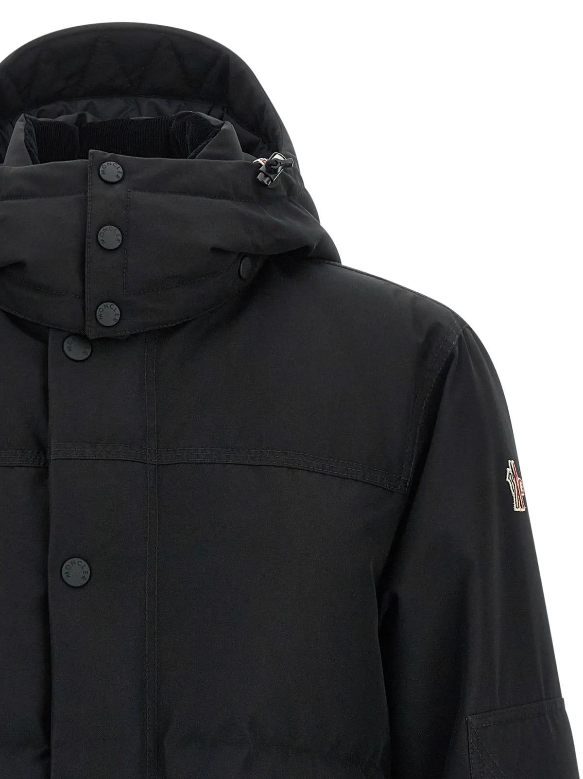 Veste moncler grenoble noire en polyester avec capuche, fermeture boutonnée et logo discret sur la manche