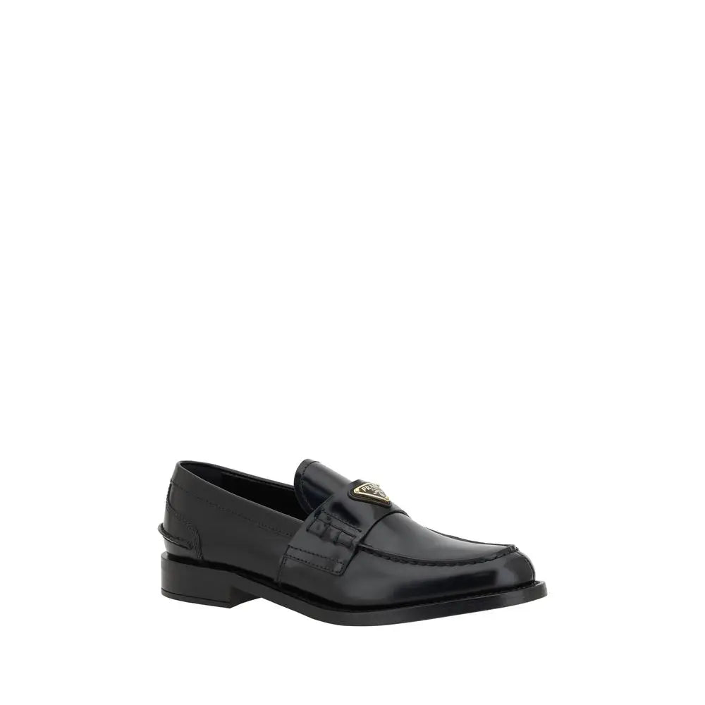 Prada black leather logo loafers with glossy finish and gold tone logo plaque