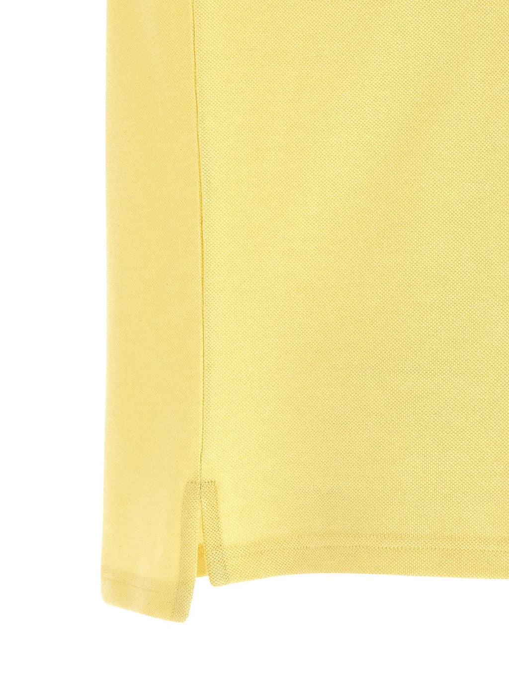 Saint laurent bicolor polo shirt en coton jaune pâle avec tissu piqué texturé et couture latérale subtile
