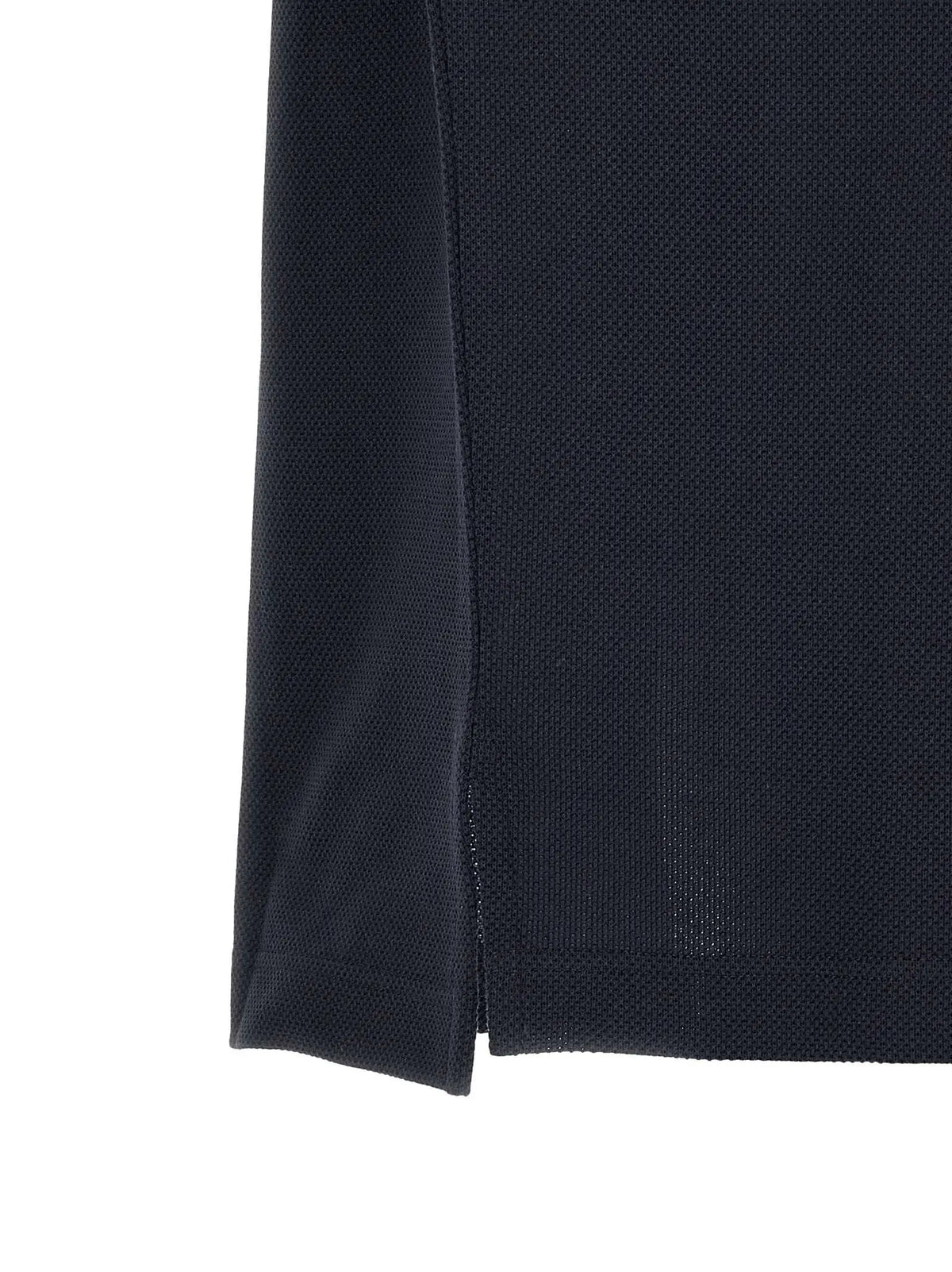 Polo bleu saint laurent en coton avec tissu piqué texturé bleu marine et couture subtile sur le côté