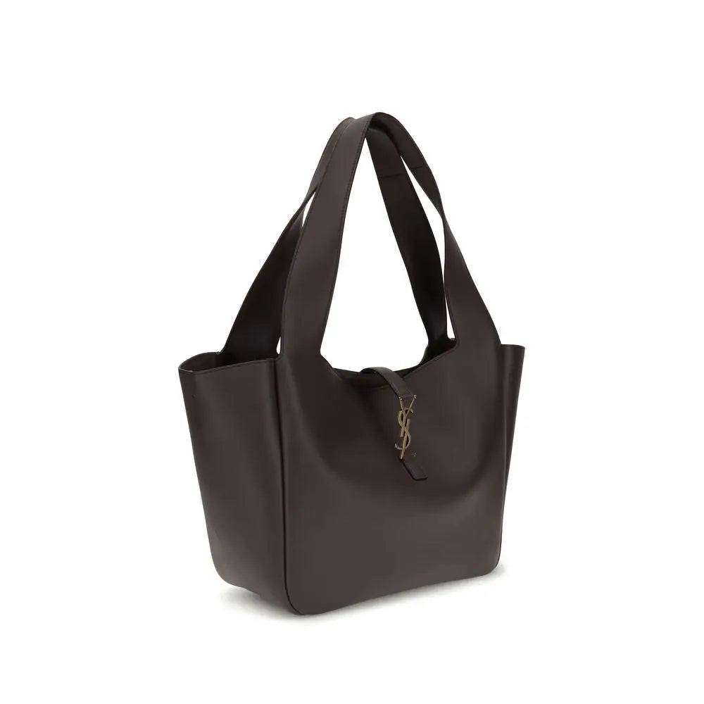 Un sac cabas saint laurent en cuir de veau brun avec logo ysl doré sur le devant