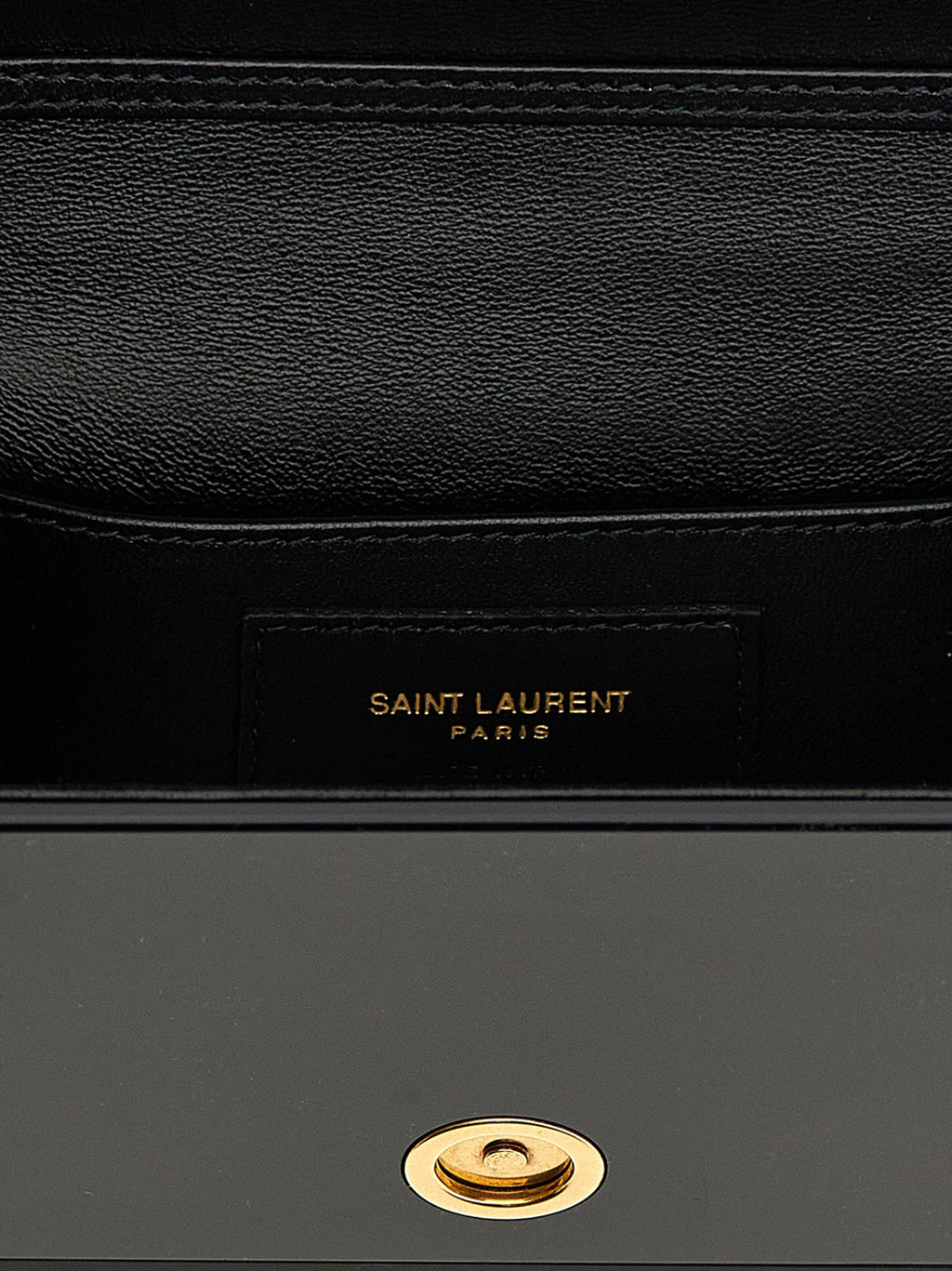 Sac à bandoulière en plexiglas noir Saint Laurent, design élégant avec détails modernes et chaîne métallique.