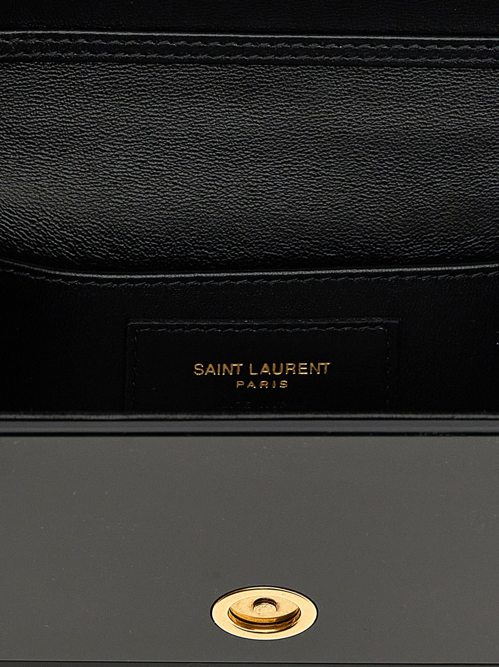 Sac à bandoulière en plexiglas noir Saint Laurent, design élégant avec détails modernes et chaîne métallique.